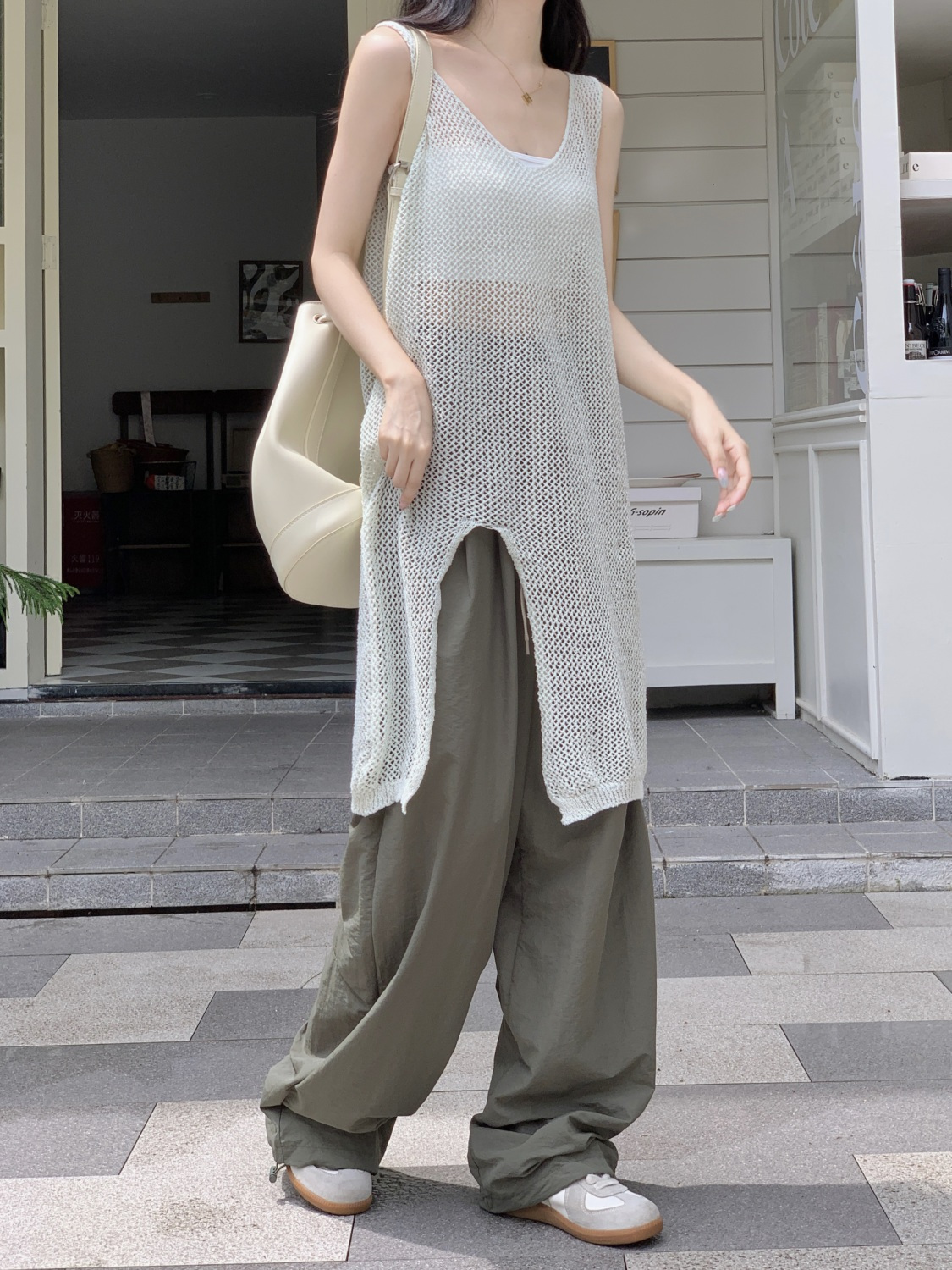 French sweet and spicy style sleeveless hollow slit ice silk knit blouse dress design sense niche outside mid-length skirt